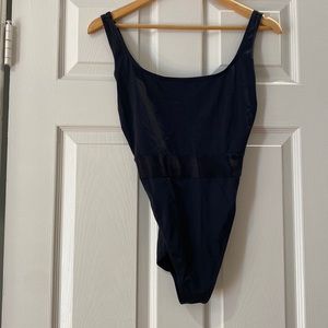 Black one-piece bathing suit, high cut and super flattering